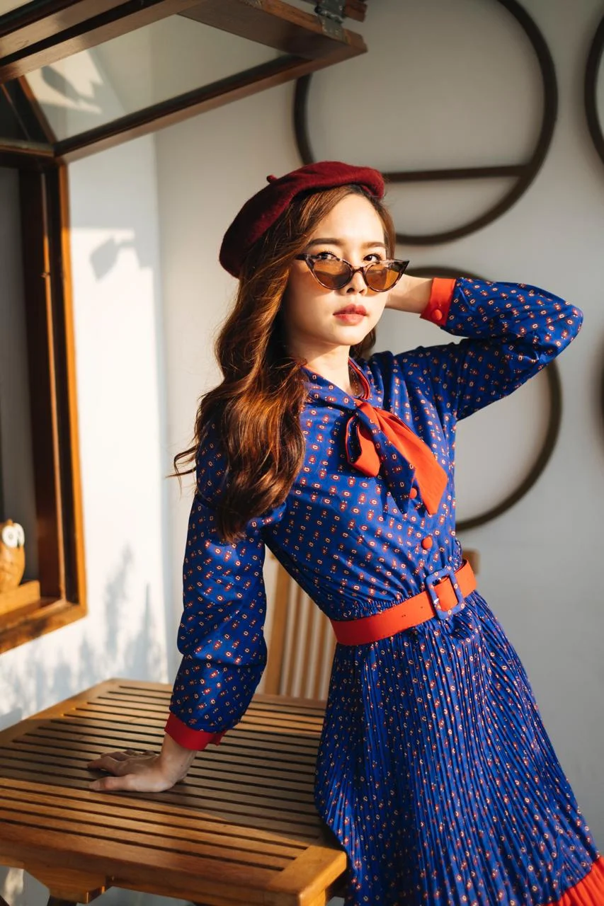 2249851559852768_tmp_portrait-young-woman-standing-by-chair-table-home